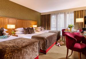 a hotel room with two beds and a desk at The Rose Hotel in Tralee +41 photos