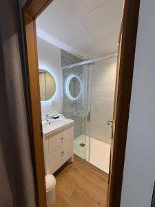 a bathroom with a shower and a sink and a toilet at Maison de charme centre Pornic in Pornic