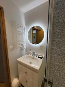 a bathroom with a sink and a mirror at Maison de charme centre Pornic in Pornic