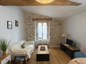 a living room with a couch and a coffee table at Maison de charme centre Pornic in Pornic +18 photos