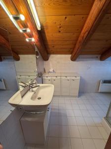 a bathroom with a sink and a mirror at Romantic Ticino Rustici in Gordola +11 photos