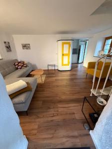 a living room with a couch and a yellow door at Romantic Ticino Rustici in Gordola