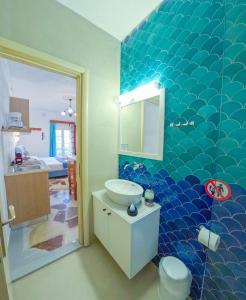 a bathroom with a sink and a mirror at CALLIOPE MAILLE studios & apartments in Myrties +167 photos