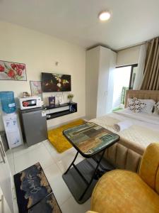 a bedroom with a bed and a table in it at Luxore Apartments Syokimau No E803 in Syokimau