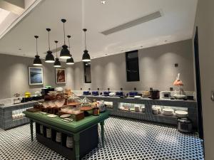 a kitchen with a table with food on it at Glond Hotel in Luang Prabang