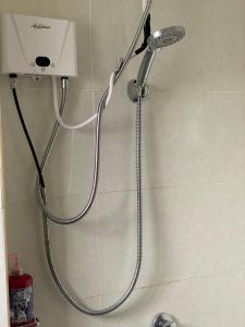a shower with a shower head in a bathroom at Luxore Apartments Syokimau No E803 in Syokimau +21 photos