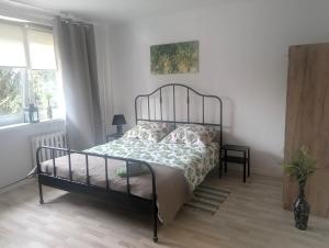 a bedroom with a bed with a metal frame at Smart Centrum in Konin