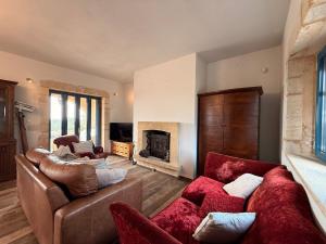a living room with two couches and a fireplace at Pantazi Beach House in Kotrónion