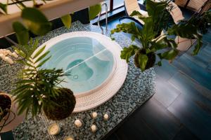 a table with a bath tub with plants on it at Design Hotel Romantick in Třeboň