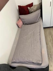 a bed with pillows on top of a wall at Cityperle Apartment in Erfurt