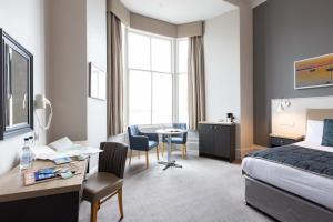 a hotel room with a bed and a desk at The Great Western Hotel in Oban