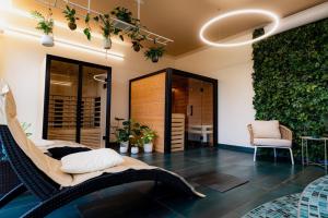 a room with a hammock and a green wall at Design Hotel Romantick in Třeboň