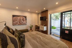 a bedroom with a bed and a desk and a television at Shelanti Guesthouse in Ceres
