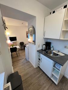 a kitchen with a sink and a counter top at Cityperle Apartment in Erfurt