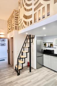 a staircase in a living room with a kitchen at Central Suites Aegina 1 in Egina