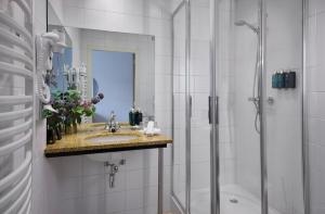 a bathroom with a sink and a shower at Dikker & Thijs Hotel in Amsterdam +76 photos