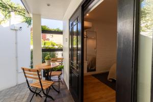 a glass door opens to a patio with a table and chairs at Shelanti Guesthouse in Ceres