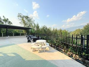 a patio with a table and benches and a fence at Khaochamao View in Ban Nam Pen +19 photos