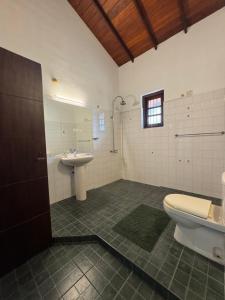 a bathroom with a toilet and a sink at The fields Malabe in Malabe +29 photos