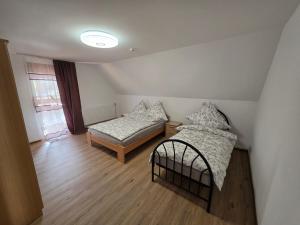 a room with two beds and a couch and a window at Haus Perla in Saarburg