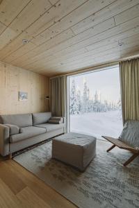 a living room with a couch and a chair at Northern Lights Ranch in Levi