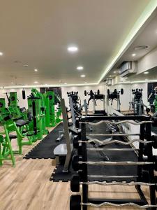 a gym with lots of tread machines and green equipment at Petra Canyon Hotel in Wadi Musa