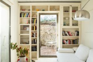 a living room with a white couch and a window at Casa Utopia in Santarcangelo di Romagna