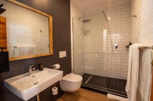 a bathroom with a sink and a toilet and a mirror at Shelanti Guesthouse in Ceres +11 photos