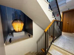 a staircase with a large vase sitting on a table at Villmor - B39 - Rabason in Benasque