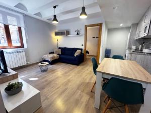 a living room with a blue couch and a table at Villmor - B39 - Rabason in Benasque