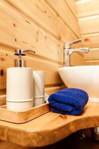 a bathroom counter with a sink and a towel at Vējciems in Liepene +95 photos