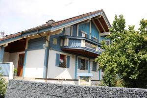 a blue and white house with a balcony at Themencamping Grünewalder Lauch in Grünewalde +5 photos