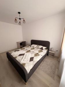 a bedroom with a bed with a quilt on it at Comodo Apartment in Turda +10 photos