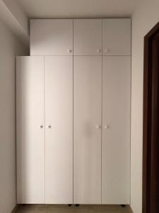 a white closet with white cabinets in a room at Comodo Apartment in Turda