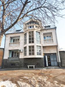 a building with a bench in front of it at New Day Hostel in Yerevan