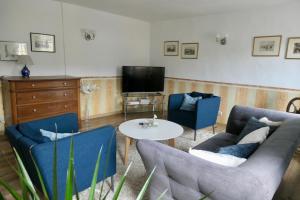 a living room with a couch and two chairs and a table at Wohnen am Trierer Moselufer in Trier