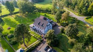 an aerial view of a large house with trees at Boutique Hotel Restaurant Hollerather Hof in Hellenthal