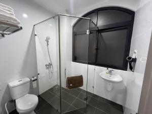 a bathroom with a shower and a toilet and a sink at Sua Chua in Phú Quốc +26 photos