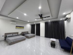a bedroom with two beds and a ceiling fan at Sua Chua in Phú Quốc
