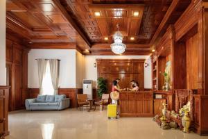 a woman standing in a living room with a yellow suitcase at Seyna Residence in Siem Reap +35 photos