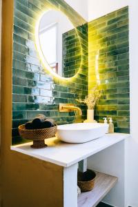 a bathroom with a sink and a mirror at Cape Diem Lodge in Cape Town