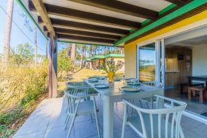 a white table and chairs on a patio at LES COTTAGES DE LEON in Léon