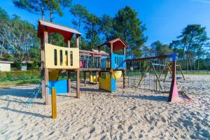 a playground in the sand on a beach at LES COTTAGES DE LEON in Léon