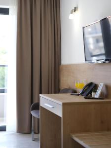 a desk with a phone and a glass of wine at Hotel D'Elegant Dubrovnik in Dubrovnik +38 photos