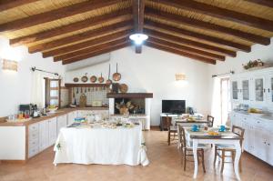 a kitchen with a table and chairs in a room at Villamarina in Aglientu +69 photos