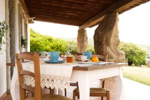 a table on the porch of a house at Villamarina in Aglientu