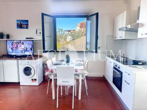 a kitchen with a table and chairs and a window at Giglio Blu 1 in Campese