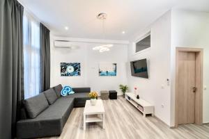 a living room with a couch and a table at Central Suites Aegina 2 in Egina