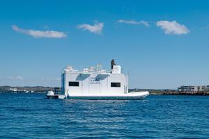 a white boat is floating in the water at Due Nodi by BarbarHouse in Gallipoli