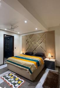 a bedroom with a large bed with a large headboard at spice villa hotel in Gajar
